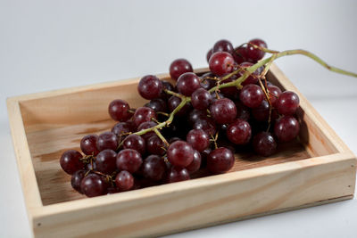 Close-up of grapes in container on table