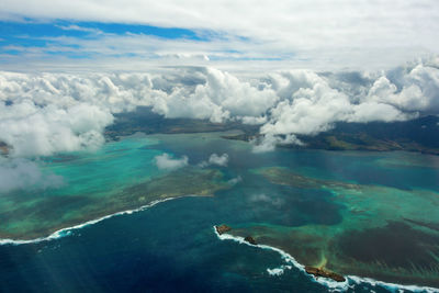 Aerial view of seascape against cloudy sky