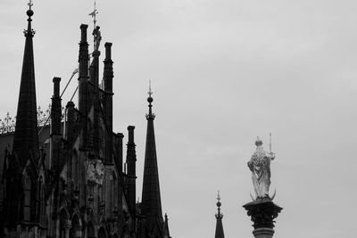 Low angle view of sculpture against building