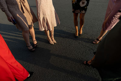 Low section of people walking on road