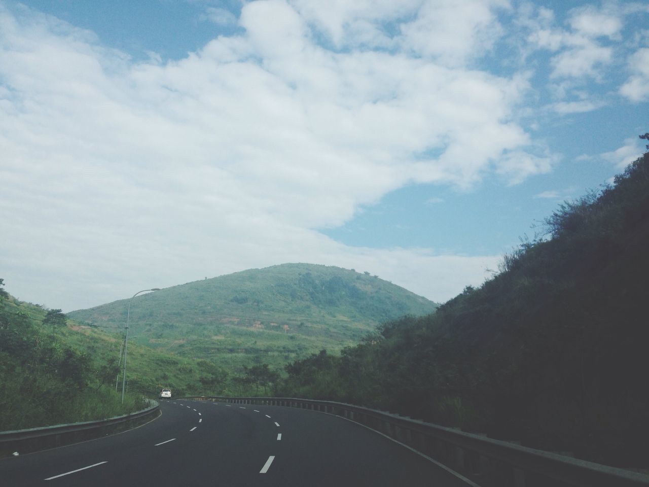 transportation, road, mountain, the way forward, sky, road marking, country road, cloud - sky, diminishing perspective, car, mountain range, landscape, land vehicle, scenics, tree, cloud, vanishing point, tranquil scene, tranquility, nature