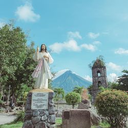 Statue against temple against sky