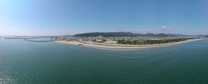 Panoramic view of bay against clear blue sky