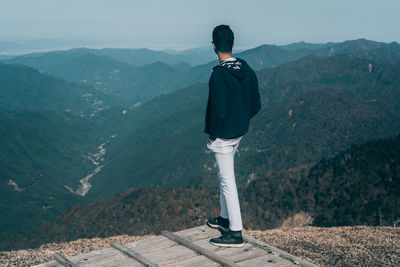 Rear view of man standing on mountain