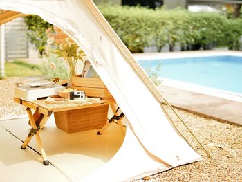 Close-up of chair by swimming pool