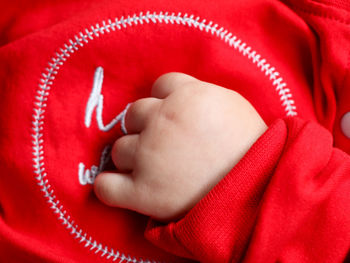 Close-up of woman holding red hand