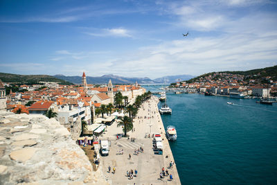 High angle view of townscape by sea against sky