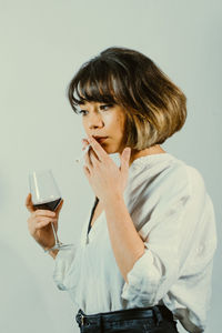 Boy looking away against white background