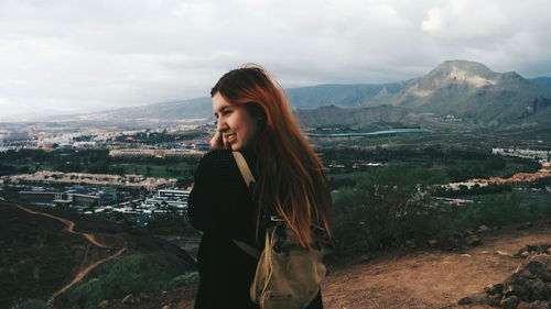 Woman looking at mountain landscape