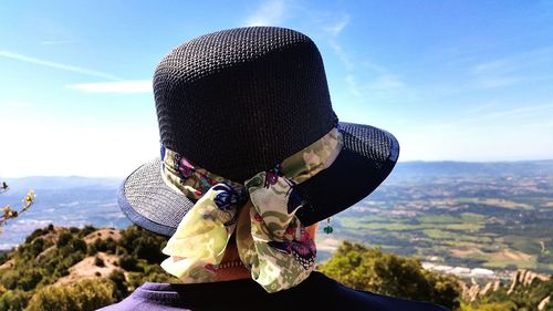 Midsection of woman against mountains against sky