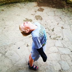 Full length of boy with arms raised