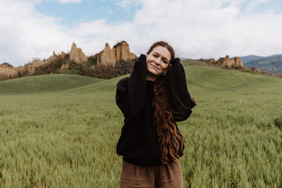 Young woman standing on field