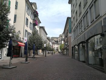 Street amidst buildings in city against sky