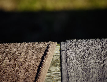 Close-up of towels on wooden railing