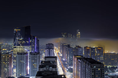 High angle view of illuminated buildings against sky at night