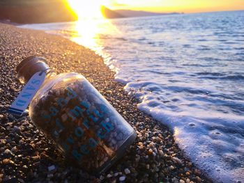 Close-up of sea shore during sunset