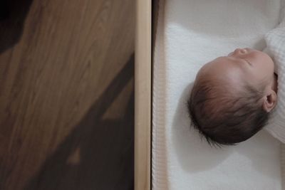 High angle view of baby sleeping at home