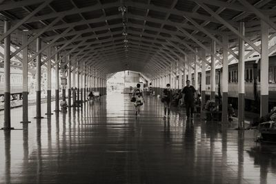 People walking in corridor of building