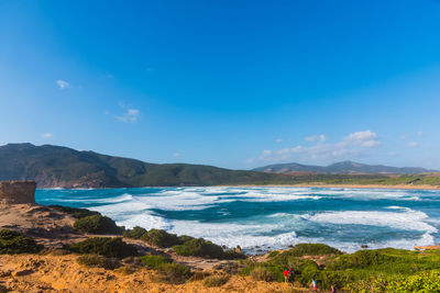 Scenic view of sea against blue sky