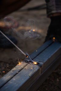 Close-up of lit candles on wood