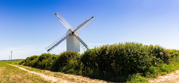 Windmill on field against clear sky