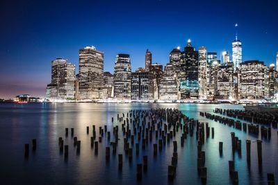 Scenic view of illuminated city at dusk