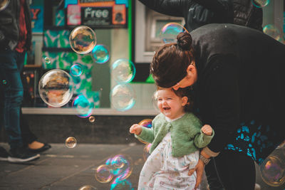 High angle view of siblings at bubbles