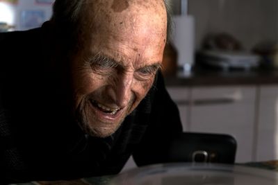 Close-up of sad man crying while sitting at home