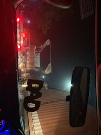 Cars on illuminated street at night