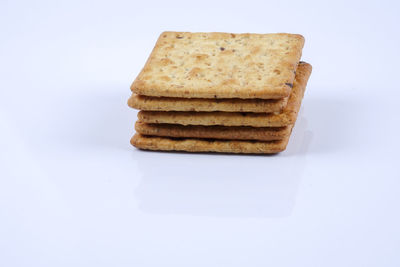 Close-up of bread stack against white background