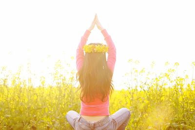 Woman with hands hair against sky