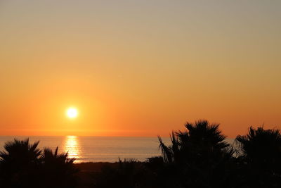 Scenic view of sea against romantic sky at sunset