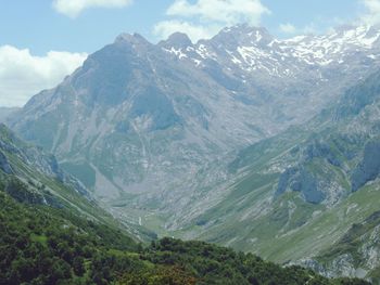 Scenic view of mountains against cloudy sky