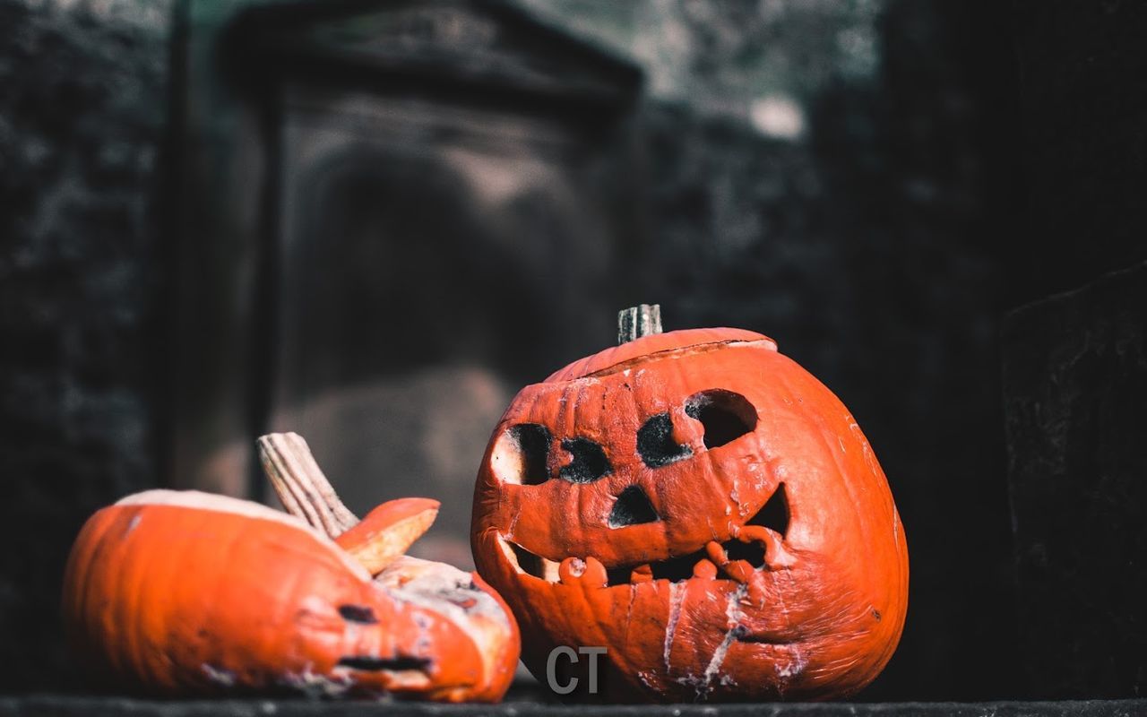 CLOSE-UP OF PUMPKIN AGAINST RED HALLOWEEN