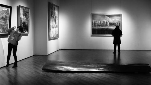 Rear view of people standing in museum