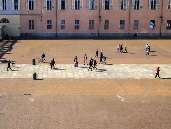 People walking on street against buildings in city