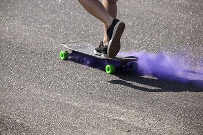 Blurred motion of person skateboarding on road