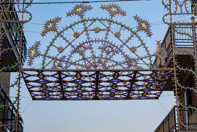 Low angle view of ferris wheel against sky