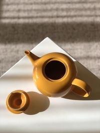 Yellow teapot on table
