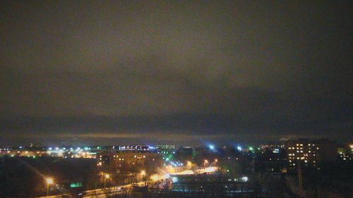 Illuminated cityscape against sky at night