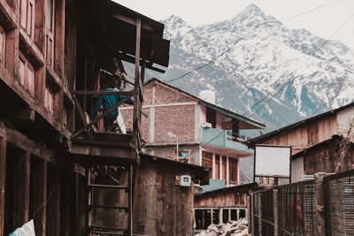 Low angle view of buildings against sky during winter