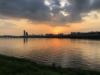 Scenic view of river against sky during sunset