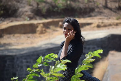 Portrait of young woman standing outdoors