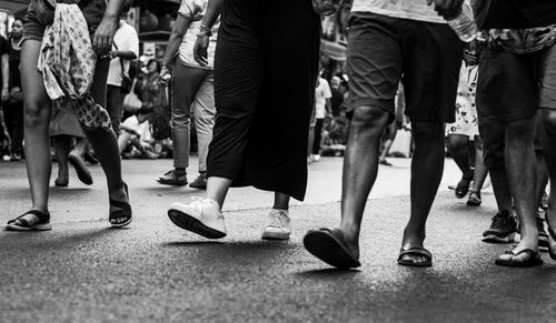 Low section of people walking on street