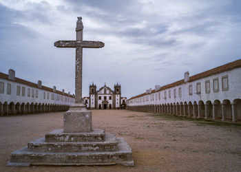 Cross at cabo espichel monastery against sky