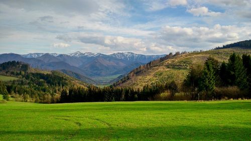 Scenic view of mountains against cloudy sky