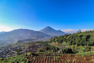 Scenic view of mountains against clear blue sky