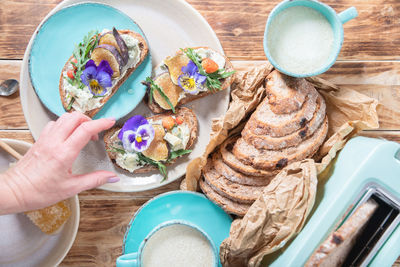 Delicious bruschetta with homemade bread, garnished with fig,soft cheese,pansies