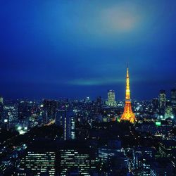 Illuminated cityscape against sky at night