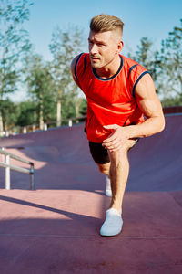 Portrait of young woman exercising on road